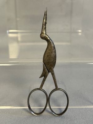 a pair of scissors sitting on top of a clear box