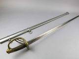 a close up of a sword with a handle on a white surface