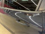 a close up of a car door handle with a sticker on it