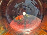 a brown bowl with a gold fish inside of it