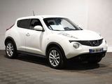 the white nissan juke suv is parked in a white room