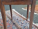 a wooden chair sitting on a rug in a room