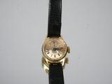 a close up of a wrist watch on a black leather strap