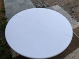 a white table that is sitting on the ground