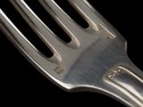 a fork that is sitting on top of a black table