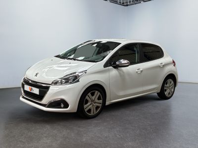 the small white car is parked in a large room