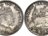 a silver coin with a picture of a woman on it