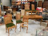 several chairs and a table in a room with a lot of junk