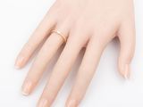 a close up of a person ' s hand with a ring on it