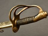 a close up of a sword with a gold handle