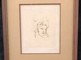 drawing of a woman ' s face in a frame on a black background