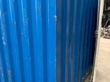 the blue container is sitting in the warehouse with the door open
