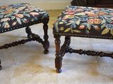 two stools that are sitting on a tile floor