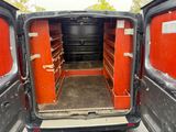 a van that has two doors open and a shelf in the back of it