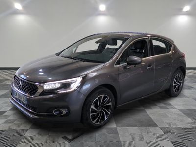 the grey car is parked on a checkered floor in the garage