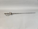 an old sword with a metal handle on a white surface