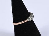 a close up of a diamond ring on a black ring stand
