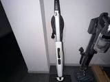 a vacuum that is sitting on the floor next to the wall