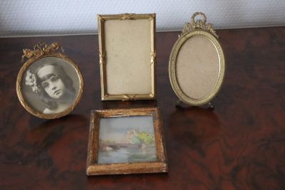 three picture frames sitting on a table next to each other