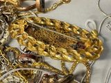 a pile of gold and silver jewelry on a table