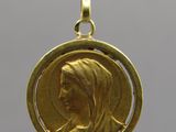 a close up of a gold coin with a woman ' s face on it