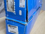two boxes of blue boxes sitting on a wooden table