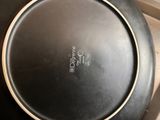 a black pan sitting on a stove top with a lid