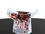 a red and white bowl sitting on a black table