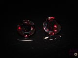 a pair of red diamonds on a black surface
