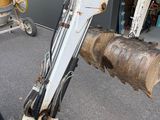 a small excavator that is parked in a garage