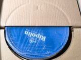 a cardboard box with a blue disc inside of it