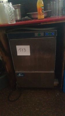 a silver dishwasher sitting on a counter in a kitchen