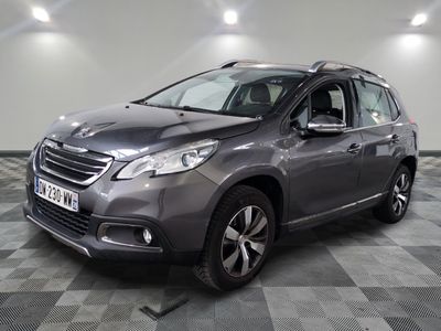 the grey car is parked on a checkered floor in a garage