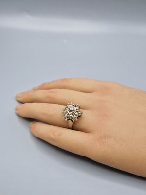a close up of a person ' s hand with a ring on it