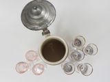 a cup of coffee next to several glasses and a teapot