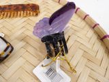 a few hair combs and a hair clip on a tray