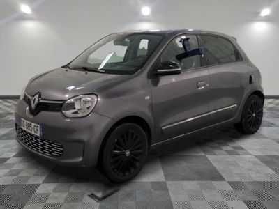 a picture of a small grey car parked in a garage