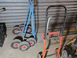 several hand trucks are lined up in front of a garage door