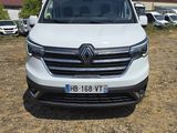 the front of a white van parked in a parking lot