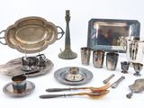a silver plate and silverware on a white table