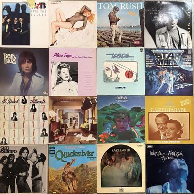 many different album covers on the wall of this room