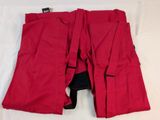 a pair of red pants that are on a bed