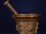an old mortar with a wooden pestula in it on a blue background