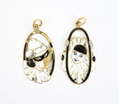 two gold and black enamel pendants with a woman ' s face in the center