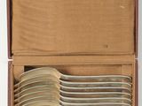 a box with a bunch of silver spoons inside of it