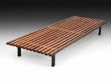 a wooden bench sitting on top of a white floor
