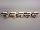 four coffee mugs are lined up in a row on a gray surface
