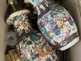 three vases in a box with pictures on them