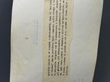 un vieux bout de papier auquel est attaché un autre bout de papier