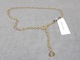 a gold chain belt with a tag attached to it